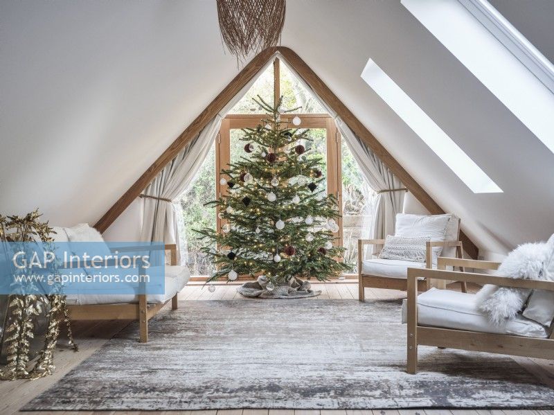 Open plan loft room featuring seating and Christmas tree