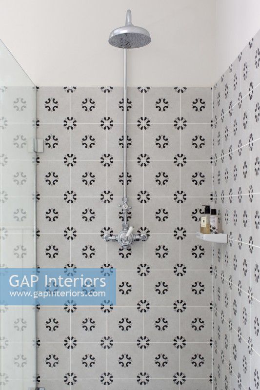 Detail of tiled shower with chrome shower head