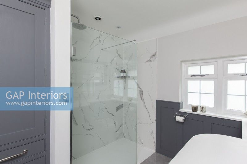 Classic shower room with grey panelling and marble tiles