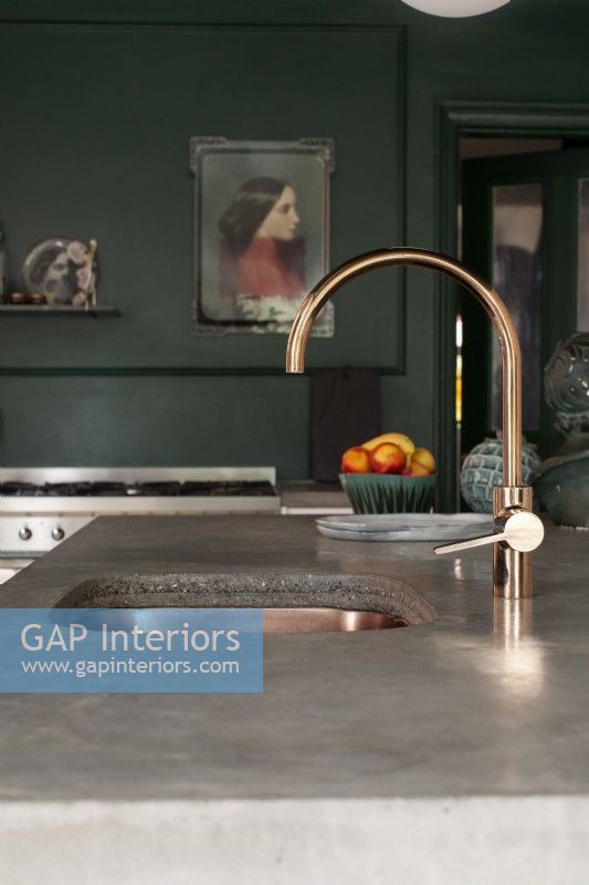Close up of copper tap on concrete worktop