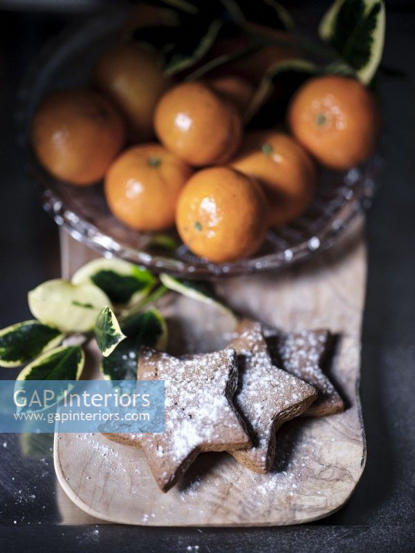 Close up of oranges and Christmas cookies