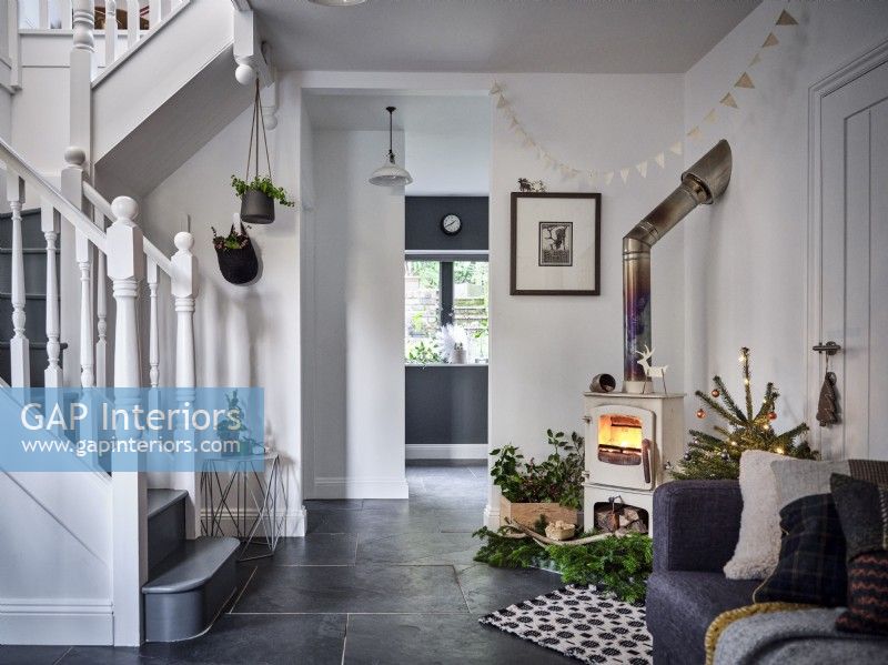 Open plan living room featuring vintage wood burning stove and staircase