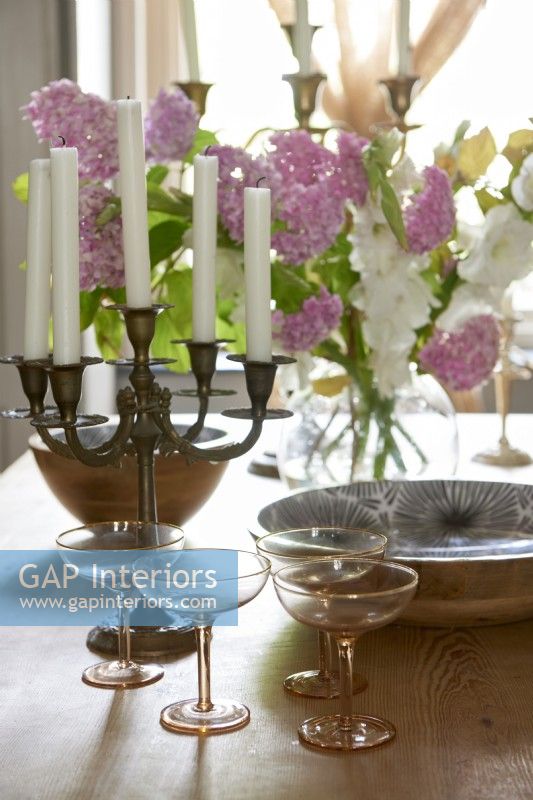 Display of candelabra and champagne glasses on a dining table. 
