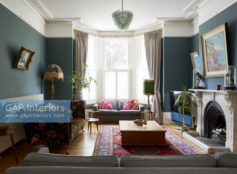 Living room in a victorian villa with velvet sofa 