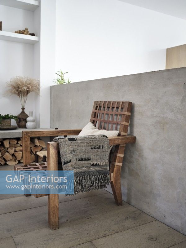 Wooden armchair with grey throw