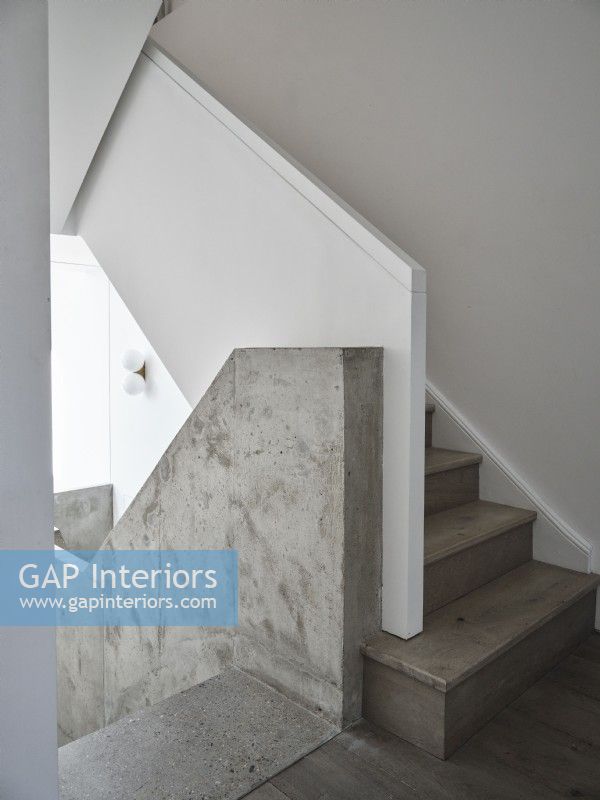 Bare hallway and stairs with concrete wall
