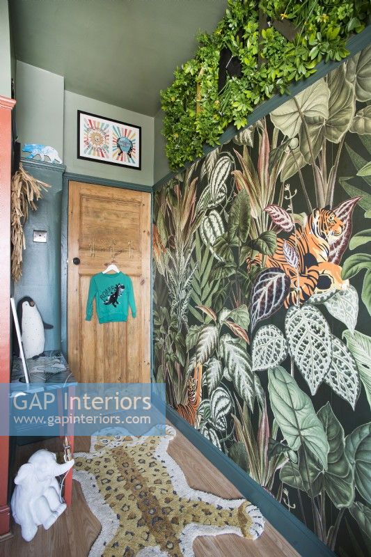 Jungle themed childrens bedroom with tropical patterned wallpaper