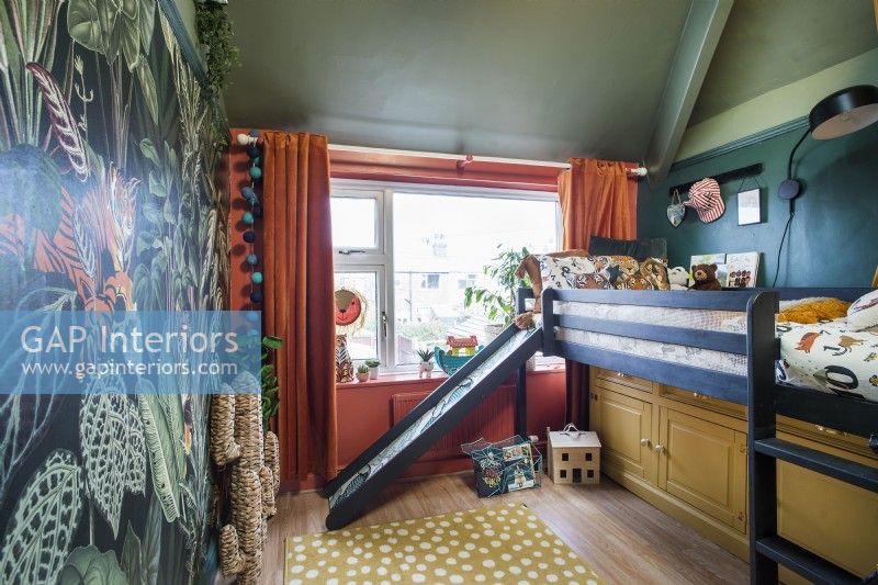 Jungle themed childrens room with slide from bunk bed