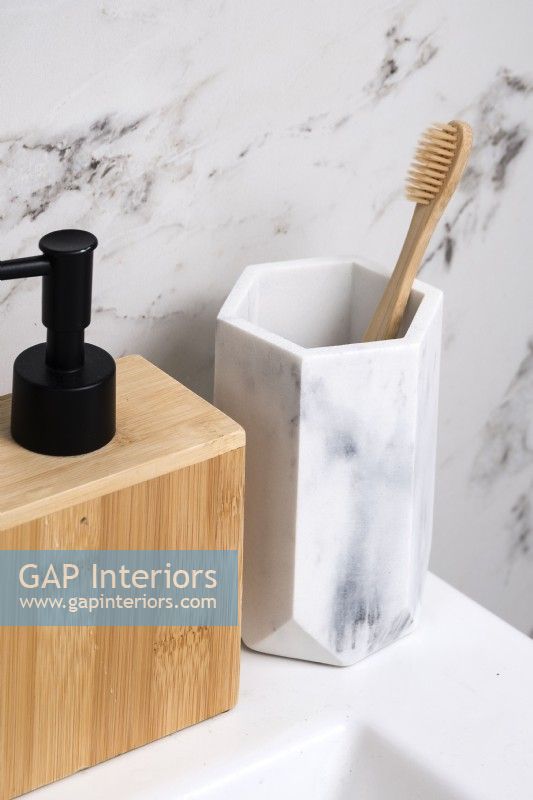 Detail of marble toothbrush holder and wooden soap dispenser