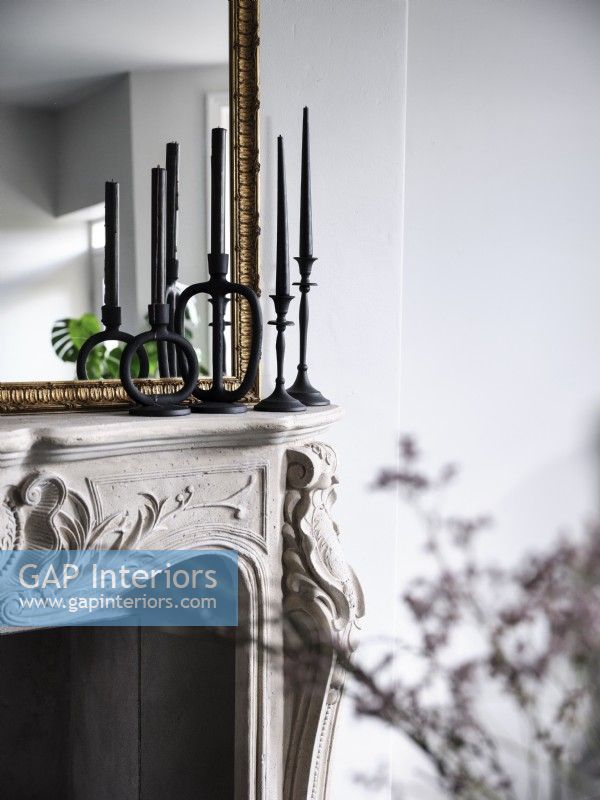 Close up of black candle sticks above fireplace