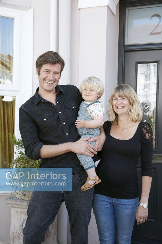 Home owner portrait Brighton Hove Victorian House, by front door. Mum Dad and baby boy