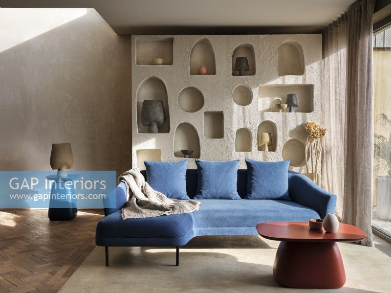 Corner sofa against sculpted storage wall