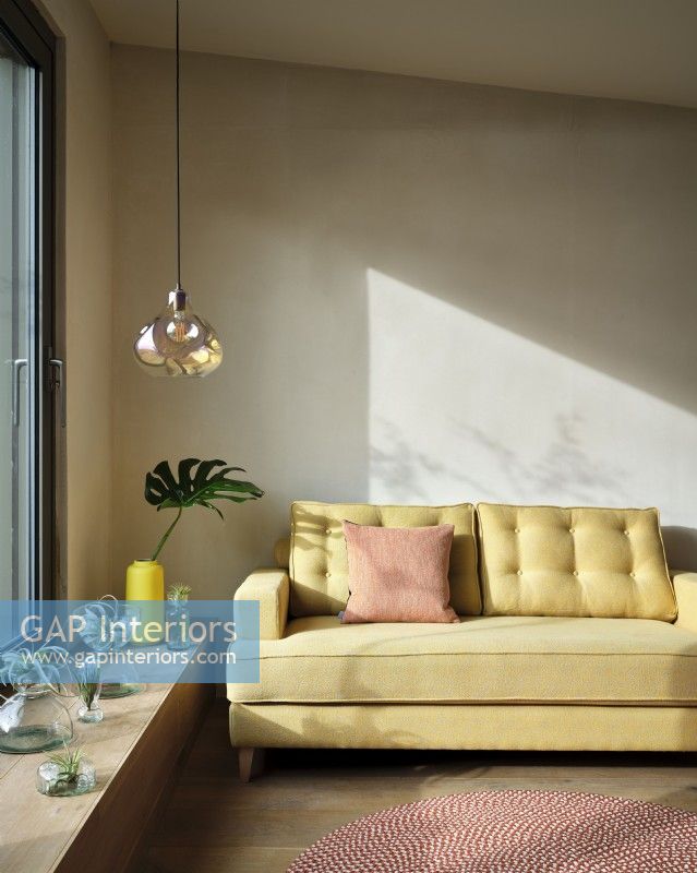 Yellow sofa with glass pendant light