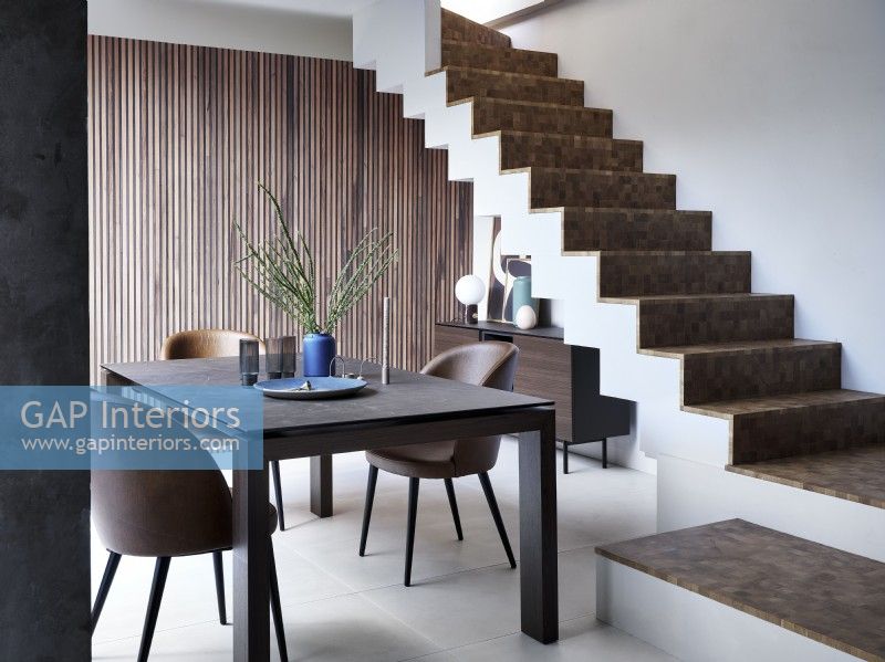 Dining room at bottom of contemporary open plan stairs