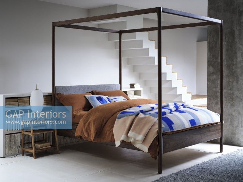 Four poster bed in open plan industrial space