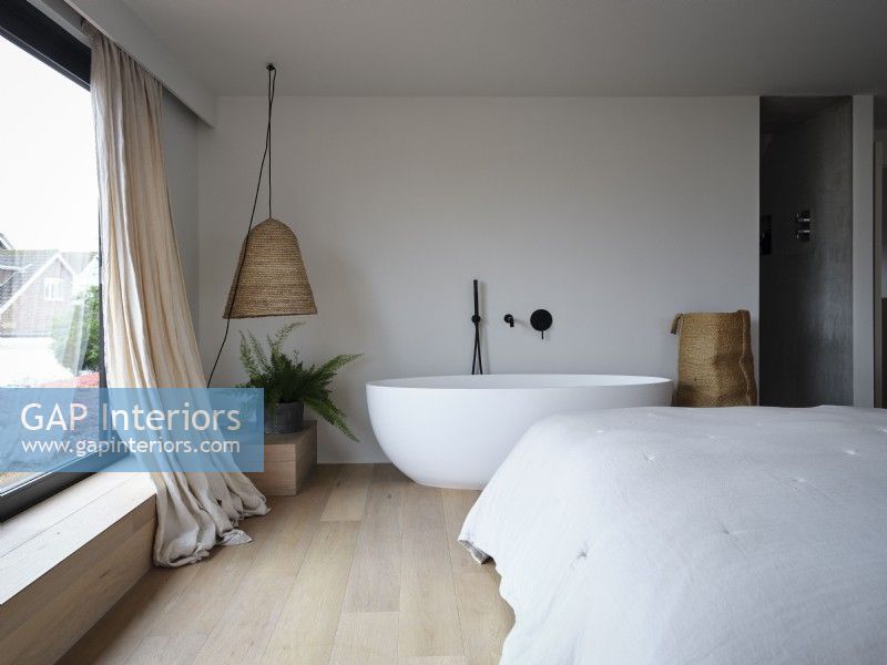 Freestanding bath in modern bedroom