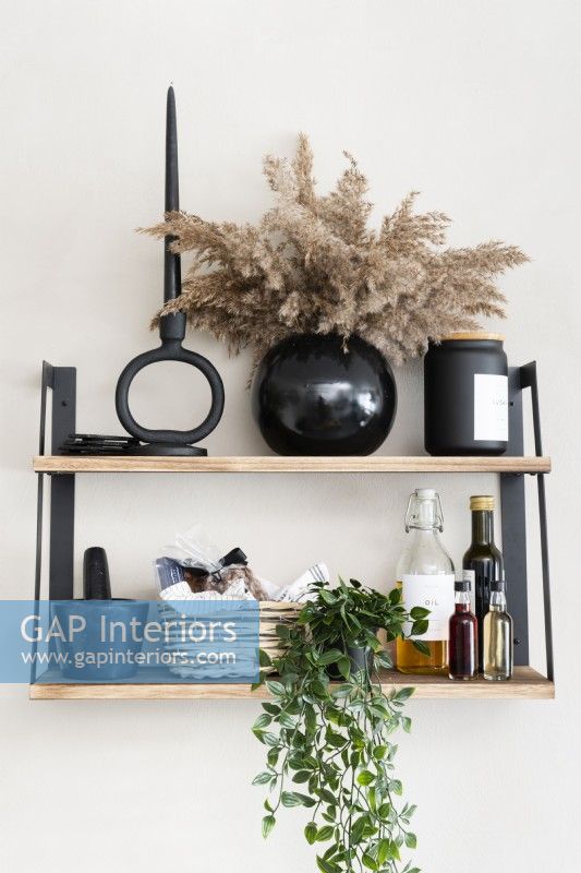 Details of wall mounted shelf in a modern kitchen with accessories