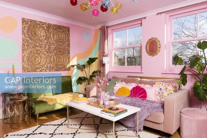 Colourful living room with pink and green velvet sofas