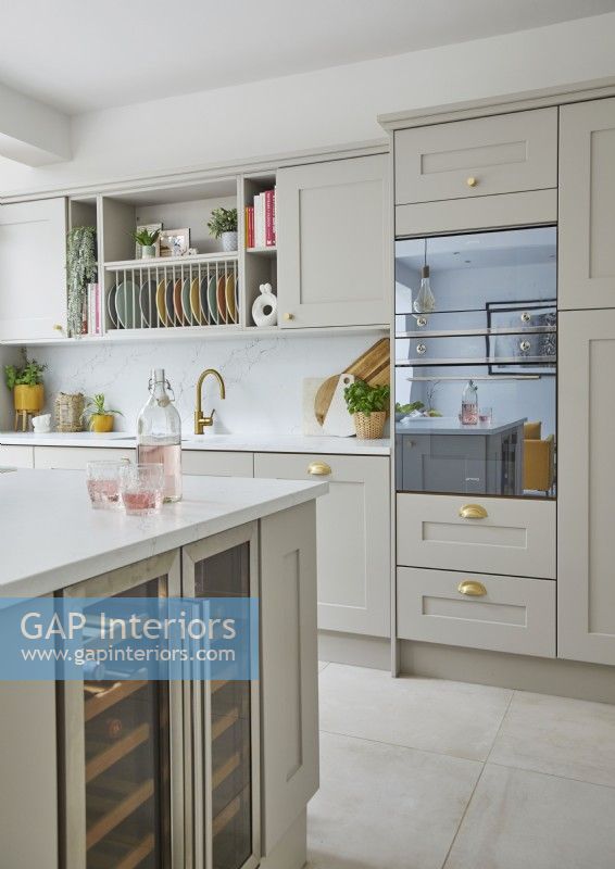 Modern kitchen with grey shaker-style cabinets and an integrated oven.