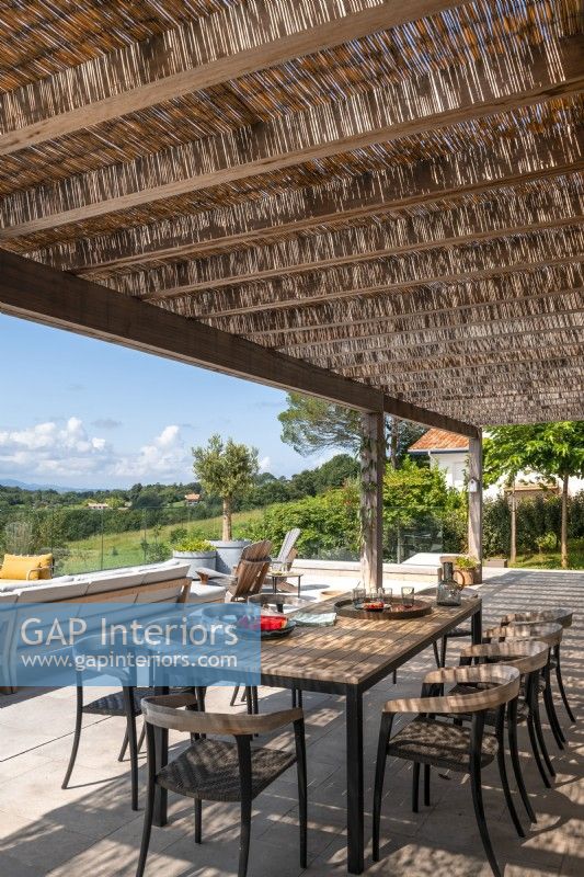 Shaded outdoor dining area on terrace with scenic views in summer
