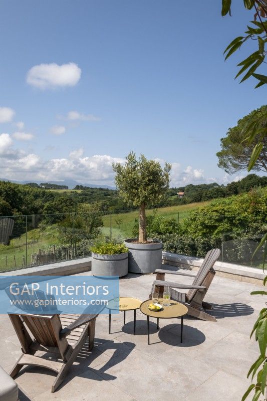 Outdoor living area on raised terrace with countryside views