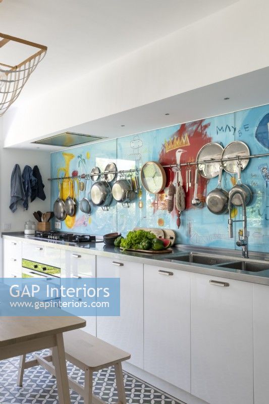 Modern kitchen with colourful splashback feature wall