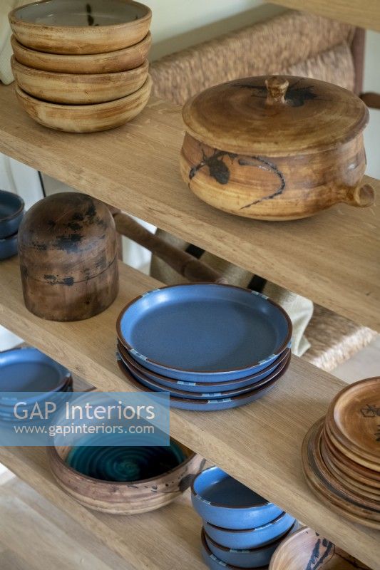 Detail of bowls and plates on wooden shelves