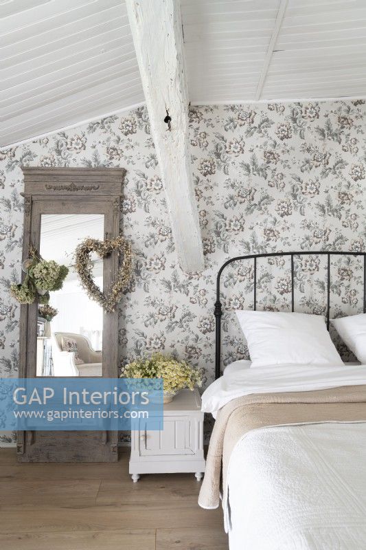 Romantic country bedroom with floral wallpaper