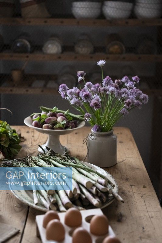 Detail of food and herbs on rustic wooden dining table 