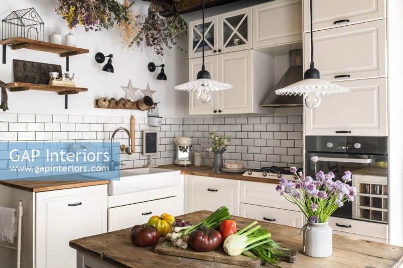 Modern country kitchen with vegetables on worktop