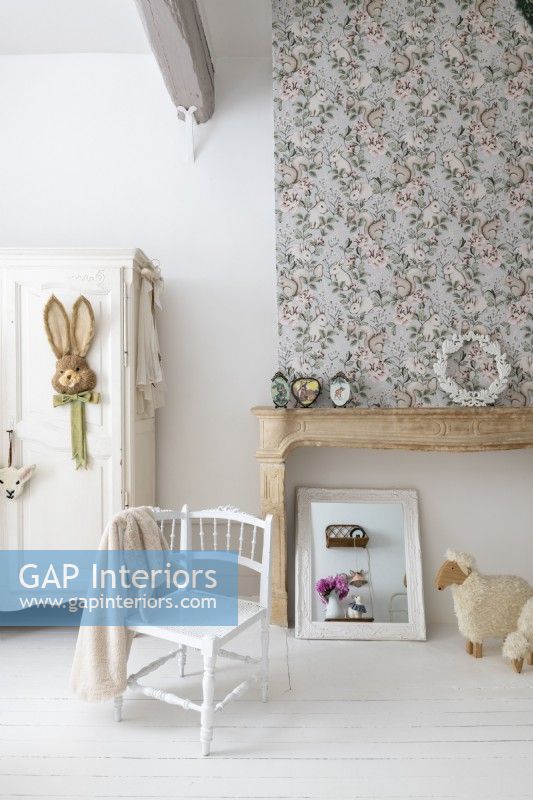 White chair and painted floorboards in childs country bedroom