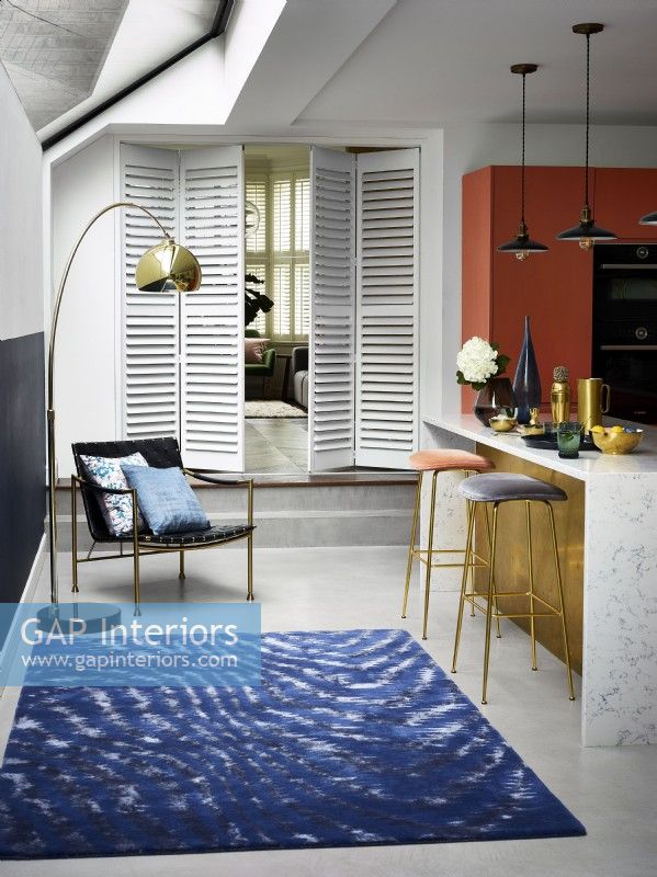 White shutters as partition in kitchen doorway