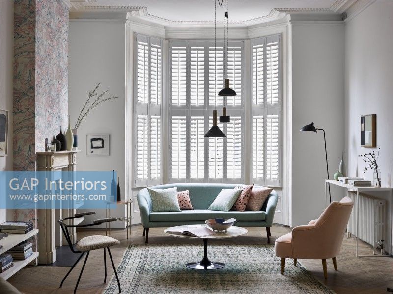 Living room with white shutters
