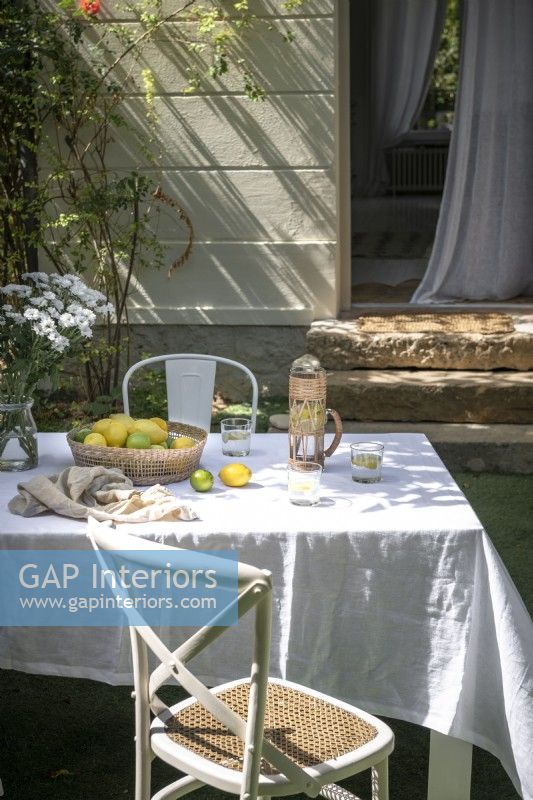 Outdoor dining table with tablecloth in summer 