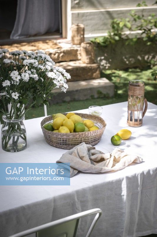 Fruit and flowers on outdoor dining table in summer