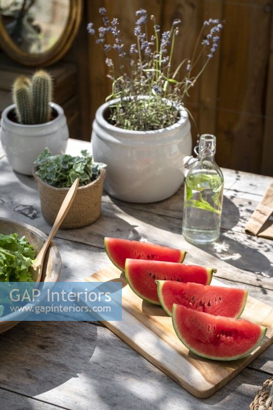 Detail of watermelon slices on outdoor dining table in summer
