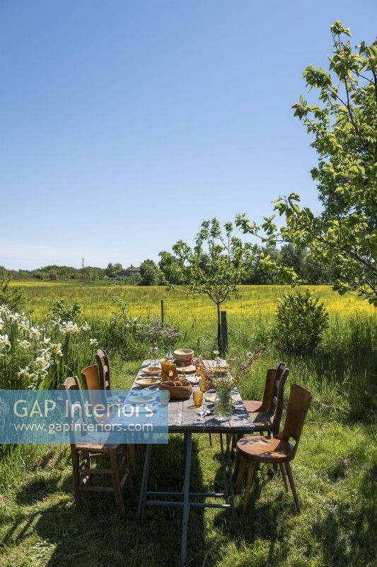 Outdoor dining table in country garden with scenic views