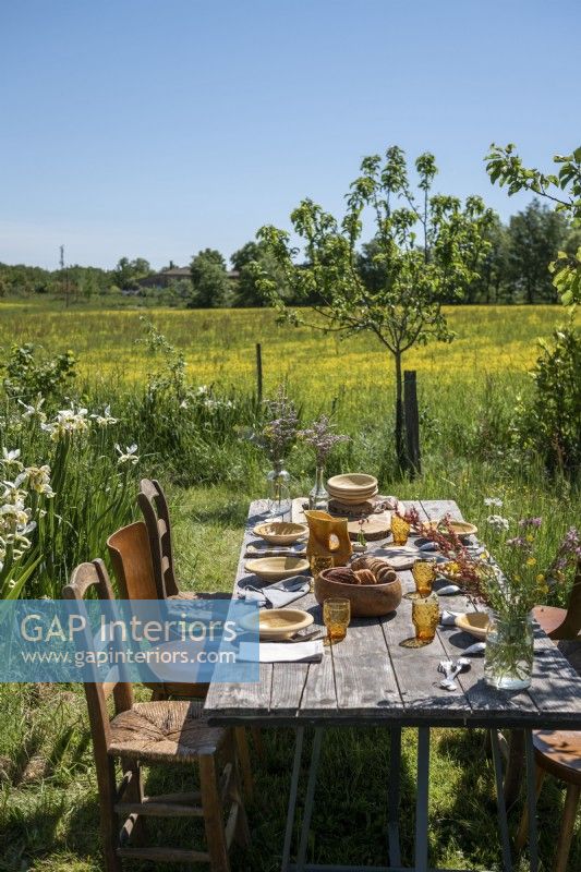 Rustic wooden outdoor dining table in country garden