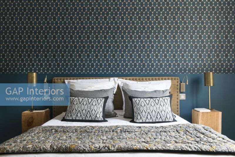 Patterned wallpaper above bed in classic style bedroom