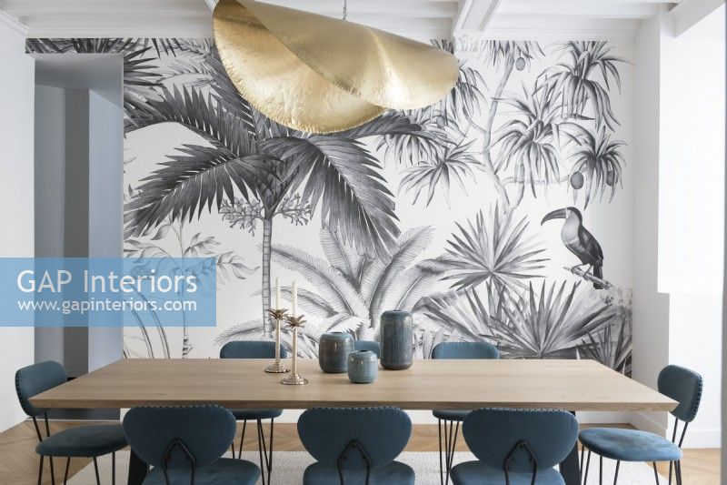 Modern dining room with grey tropical patterned wallpaper wall