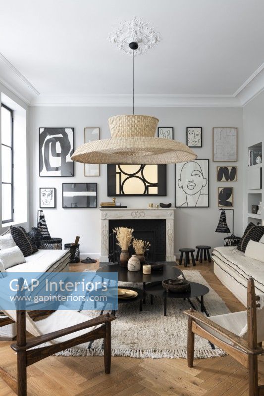 Modern artwork display around fireplace in modern living room
