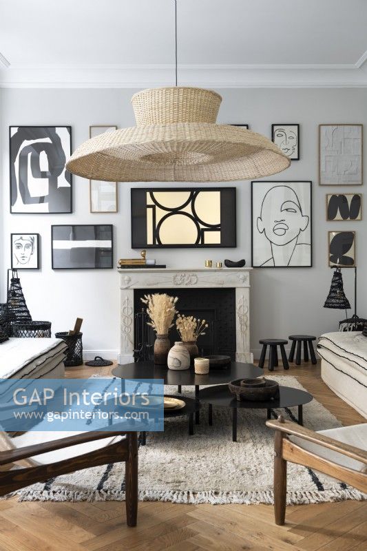 Large lampshade and display of artwork in modern living room