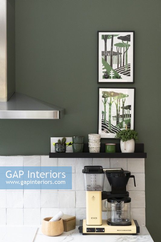 Modern artwork on green painted kitchen wall - detail