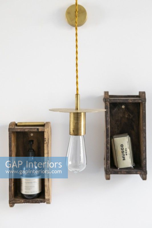 Tiny wooden wall mounted shelves and pendant light detail