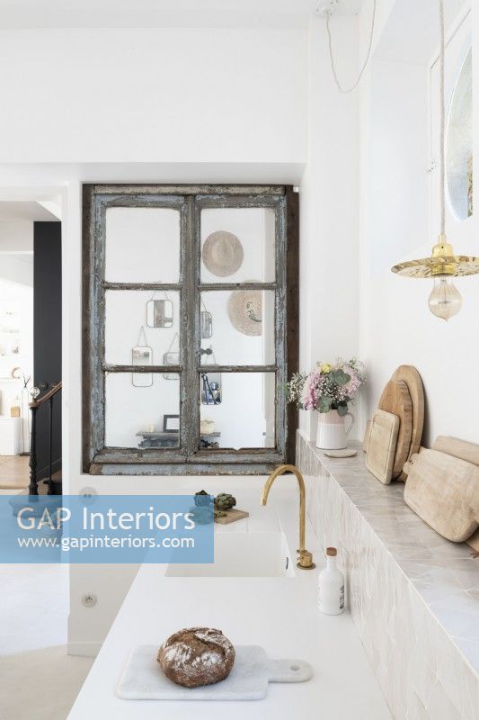 Modern white kitchen with grey distressed wooden window frame