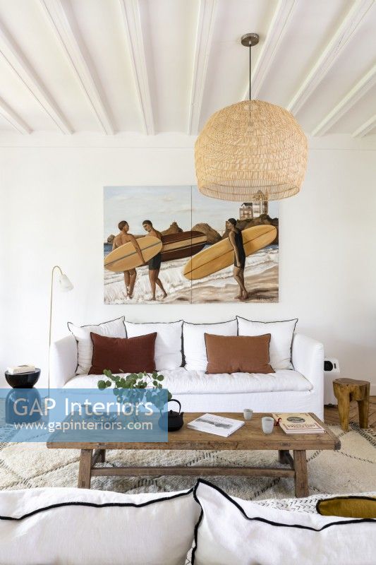 Coastal scene painting of surfers in modern living room