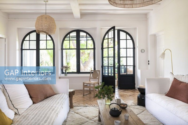 Large arched windows and doors in modern living room