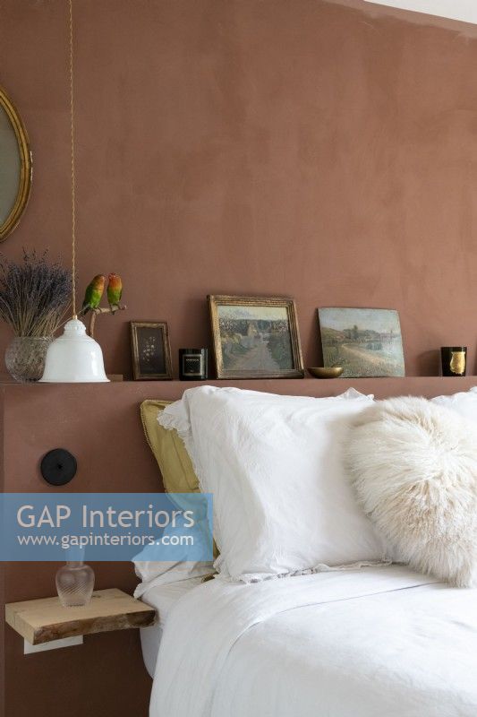 Brown painted walll and headboard in modern bedroom