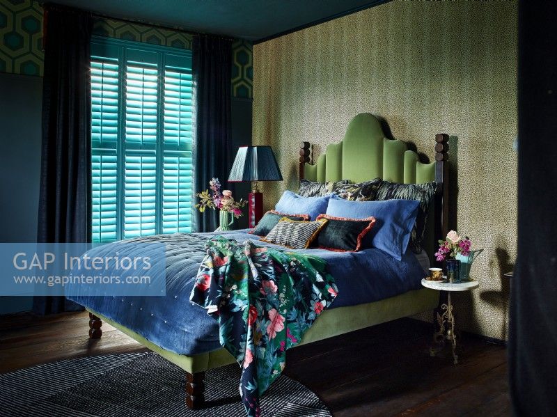 Traditional bedroom with turquoise shutters