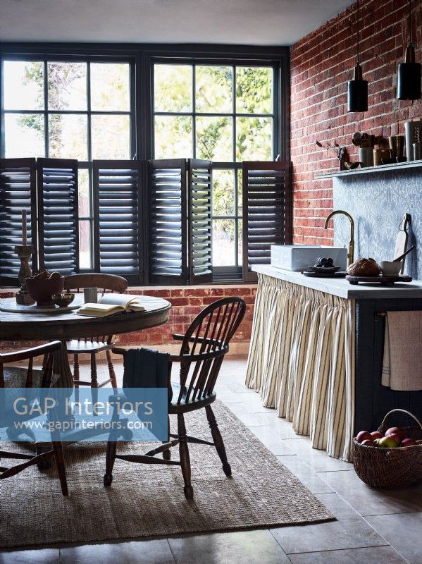 Traditional kitchen with black shutters cracked open